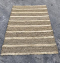 Light brown with tan stripes area rug