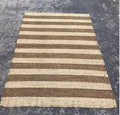 Dark brown and light tan striped area rug